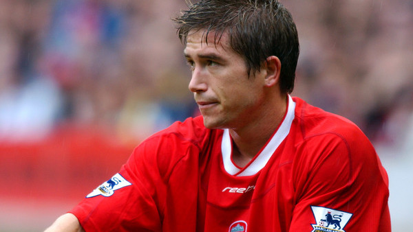 Liverpool's Harry Kewell sits dejected on the floor