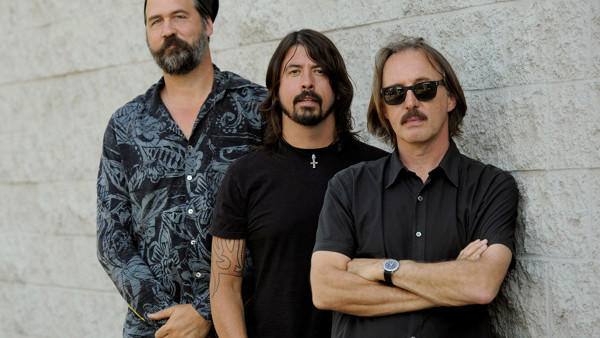 Krist Novoselic, left, and Dave Grohl, center, former members of the band Nirvana, pose with Butch Vig, producer of their landmark 1991 album 