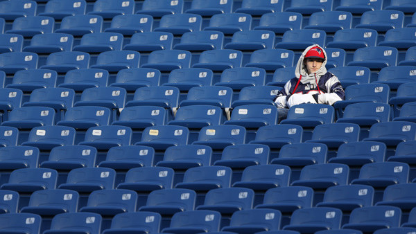 A fan sits in an empty section of seats prior to an NFL football game between the New England Patriots and the Indianapolis Colts at Gillette Stadium in Foxborough, Mass., Sunday, Nov. 18, 2012. (AP Photo/Michael Dwyer)