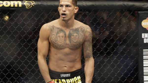 Anthony Pettis runs on the ring before fighting with Donald Cerrone during UFC Lightweight Championship on FOX 6 at the United Center in Chicago, Saturday, Jan. 26, 2013. Pettis won the bout. (AP Photo/Nam Y. Huh)