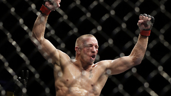 Georges St. Pierre, of Canada, left, reacts following his UFC 167 mixed martial arts championship welterweight bout versus Johny Hendricks on Saturday, Nov. 16, 2013, in Las Vegas. St. Pierre won by split decision. (AP Photo/Isaac Brekken)