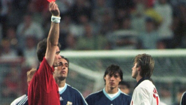 FILE - In this June 30, 1998 file photo, England's David Beckham receives a red card from Danish referee Kim Milton Nielsen, during England's World Cup second round soccer match against Argentina, in Saint Etienne, France. On this day: Beckham bec