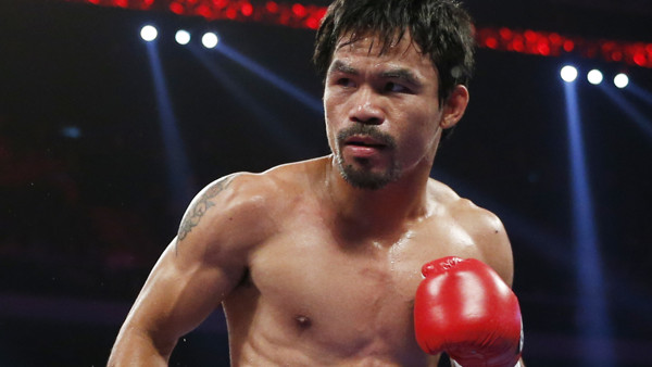 WBO welterweight champion Manny Pacquiao of the Philippines, fights during his world welterweight title boxing match against WBO junior welterweight champion Chris Algieri of the U.S. at the Venetian Macao in Macau, Sunday, Nov. 23, 2014. (AP Photo/Kin Ch