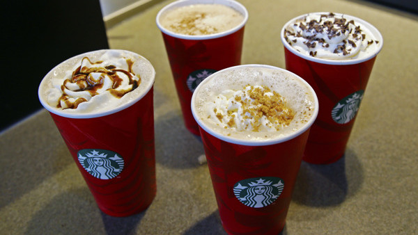 This Monday, Nov. 24, 2014 photo shows four limited-time Starbucks coffee drinks, clockwise from left, the Gingerbread Latte, the Eggnog Latte, the Peppermint Mocha, and the new Chestnut Praline Latte, at a Starbucks store in Seattle. Starbucks is one of 