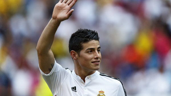 FILE - In this July 22, 2014, file photo, Real Madrid player James Rodriguez, from Colombia, waves during his official presentation at the Santiago Bernabeu stadium in Madrid, Spain. Rodriguez has been named sportsman of the year in his native Colombia, T