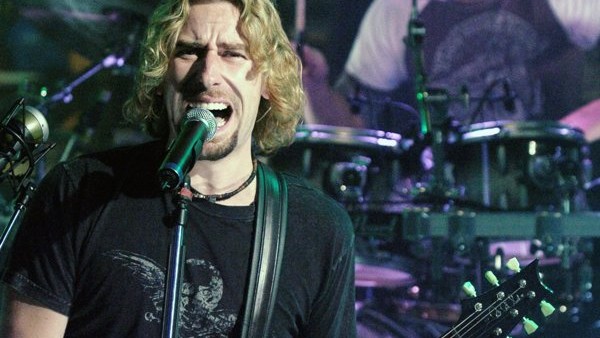 Chad Kroeger, left, and drummer Daniel Adair of Nickelback perform at MuchMusic in Toronto Thursday Oct. 13, 2005. (AP Photo/CP, Aaron Harris)