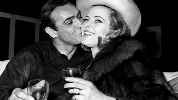 Honor Blackman (Pussy Galore) meets Sean Connery (James Bond) and quickly gets on good terms with him during a press conference at Pinewood Studios, for the third Bond film, 'Goldfinger'.