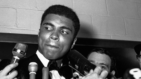 ADVANCE FOR USE SUNDAY, FEB. 23, 2014 AND THEREAFTER - FILE - In this March 29, 1966 file photo, reporters surround Muhammad Ali at Toronto's Maple Leaf Gardens after he won a unanimous decision over Canadian George Chuvalo. (AP Photo)