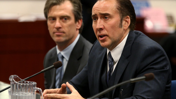 FILE - In this Tuesday, May 7, 2013 file photo, actor Nicolas Cage testifies in support of a bill proposing tax incentives to filmmakers at the Legislative Building Carson City, Nev. Cage's agent Michael Nilon is at left. Nevada lawmakers are hoping to br