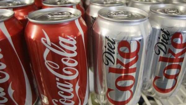 Cans of Coca-Cola and Diet Coke are shown in a cooler in Anne's Deli Thursday, March 17, 2011, in Portland, Ore. Coca-Cola is winning the fight for America's soda drinkers. Diet Coke bubbled up into the second spot in the U.S. soft drink market, e