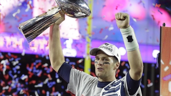 New England Patriots quarterback Tom Brady celebrates with the Vince Lombardi Trophy after the NFL Super Bowl XLIX football game against the Seattle Seahawks Sunday, Feb. 1, 2015, in Glendale, Ariz. The Patriots won 28-24. (AP Photo/Michael Conroy)