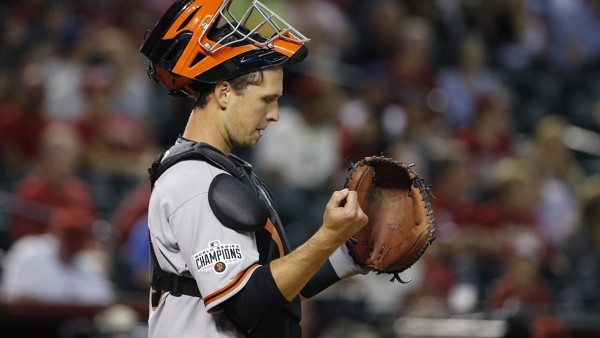 San Francisco Giants' Buster Posey pauses behind home plate during the seventh inning of an opening day baseball game against the Arizona Diamondbacks Monday, April 6, 2015, in Phoenix. The Giants defeated the Diamondbacks 5-4. (AP Photo/Ross D. Franklin)