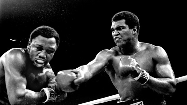 Spray flies from the head of challenger Joe Frazier as heavyweight champion Muhammad Ali connects with a right in the ninth round of their title fight in Manila, Philippines, October 1, 1975. Ali won the fight on a decision to retain the title. (AP Photo/