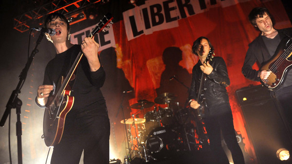 Pete Doherty (left) and Carl Barat (centre) of the Libertines perform on stage at the HMV Forum in Highgate, London.
