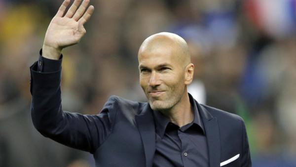 Former France's soccer player Zinedine Zidane waves to spectators prior to the international friendly soccer match between France and Brazil at the Stade de France, north of Paris, France, Thursday, March 26, 2015. (AP Photo/Francois Mori)