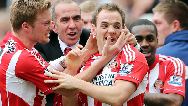 Sunderland's manager Paolo Di Canio, center, celebrates with David Vaughan, right, after scoring his goal during their English Premier League soccer match against Newcastle United at St James' Park, Newcastle, England, Sunday, April 14, 2013. (AP
