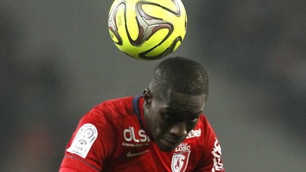 Lille's Idrissa Gueye heads the ball during his French League one soccer match against PSG at the Lille Metropole stadium, in Villeneuve d'Ascq, northern France, Wednesday, Dec. 3, 2014. (AP Photo/Michel Spingler)