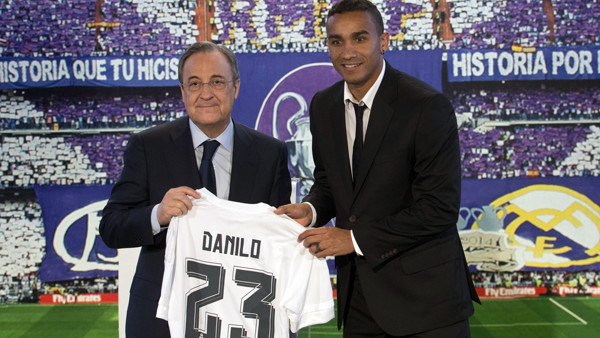 Real Madrid's new signing Danilo, right, displays his new shirt alongside club president Florentino Perez during his presentation at the Santiago Bernabeu stadium in Madrid, Spain, Thursday, July 9, 2015. Brazilian defender Danilo previously played fo