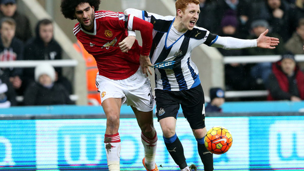 Newcastle United's Jack Colback, right, vies for the ball with Manchester United's Marouane Fellaini, left, during the English Premier League soccer match between Newcastle United and Manchester United at St James' Park, Newcastle, England, Tu