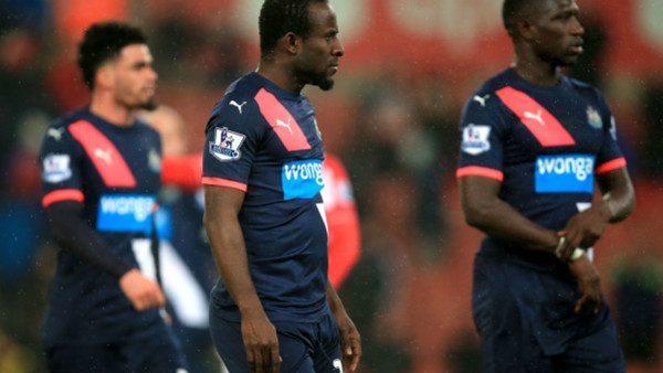 Newcastle United's Seydou Doumbia (centre) walks off the pitch dejected after the final whistle during the Barclays Premier League match at the Britannia Stadium, Stoke-on-Trent.