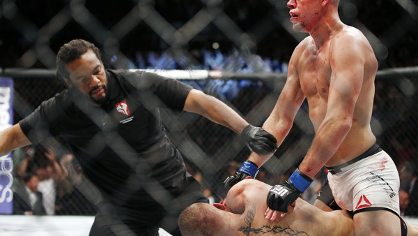 Referee Herb Dean stops the fight shortly after Nate Diaz defeats Conor McGregor in a second round submission victory during their UFC 196 welterweight mixed martial arts match, Saturday, March 5, 2016, in Las Vegas. Diaz won by submission. (AP Photo/Eric