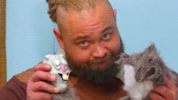 Bray Wyatt, a grown man, and his two little toys